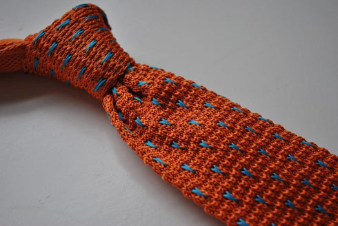 orange skinny knitted tie with light  blue pin spots
